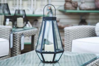 Metal lantern with flickering candle